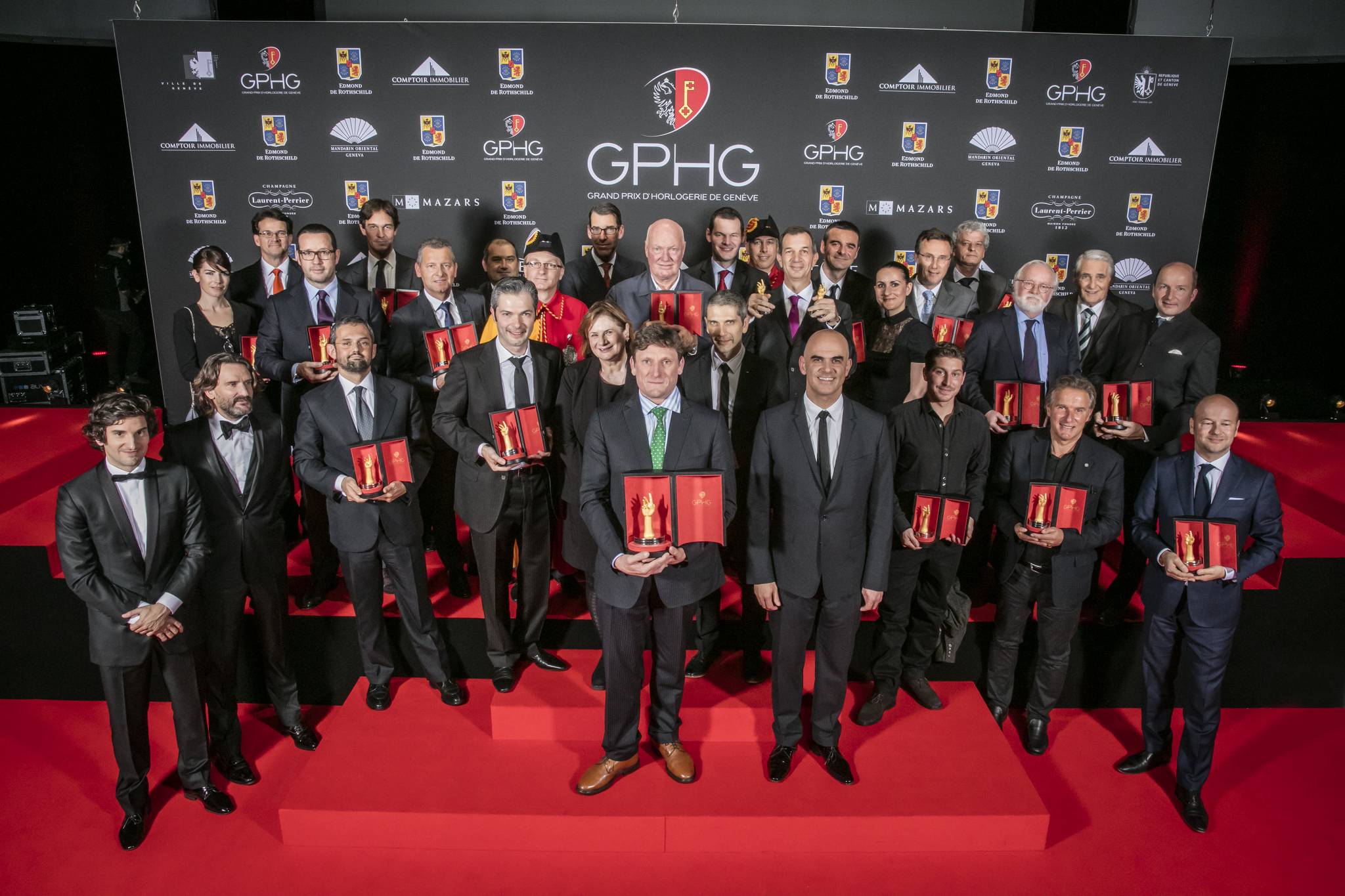 The Prize winners of the Grand Prix d’Horlogerie de Genève 2015 : Gaspard Proust (MC), Frédéric Beigbeder (MC), Stefano Macaluso (Product Development &amp; Design Director of Girard-Perregaux), Yannick Pintus (watchmakers of Vacheron Constantin), Esther Alder ( Mayor of the City of Geneva), Stephen Forsey (Co-founder of Greubel Forsey), Micke Pintus (watchmakers of Vacheron Constantin), Alain Berset (Federal Councillor), Florian Preziuso et Antoine Preziuso (Founder of Antoine Preziuso and his son), Christian Lattmann (Senior Executive Vice President of Jaquet Droz), Aurélie Picaud et Sean Gilbertson (Timepieces Director and CEO of Fabergé), François Bennahmias (CEO of Audemars Piguet), Laurent Dordet (CEO of La Montre Hermès), Patrik Hoffmann (CEO of Ulysse Nardin), Jean-Luc Perrin (watchmaker of Vacheron Constantin), Christian Selmoni (Artistic director of Vacheron Constantin), Jean-Claude Biver (President of the Watch Division of the LVMH Group and Chairman of Hublot), Pierre Maudet (State Councillor), Philippe Léopold-Metzger (CEO of Piaget), Richard Habring et Maria Kristina Habring (Founders and CEOs of Habring2), Philippe Peverelli (CEO of Tudor), Lionel a Marca (Vice President, Head of Technical and Development Management of Blancpain), Laurent Ferrier (Founder of Laurent Ferrier), Carlo Lamprecht (President of the Foundation of the GPHG), Kari Voutilainen (Founder of Voutilainen)